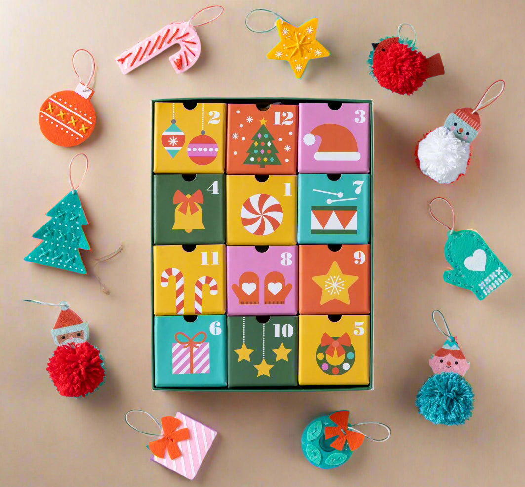 Colorful a12-crafts-of-christmas-advent-calendar with Christmas-themed decorations on a light gray background
