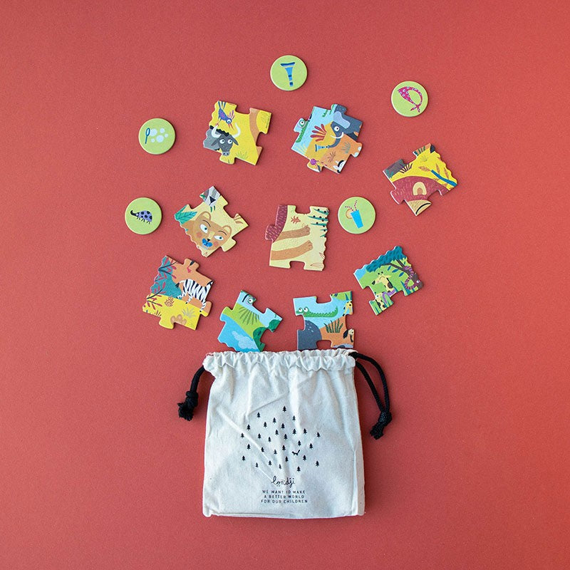 24-piece-look-and-find-pocket-puzzle-my-little-jungle pieces on a red background with a drawstring bag.