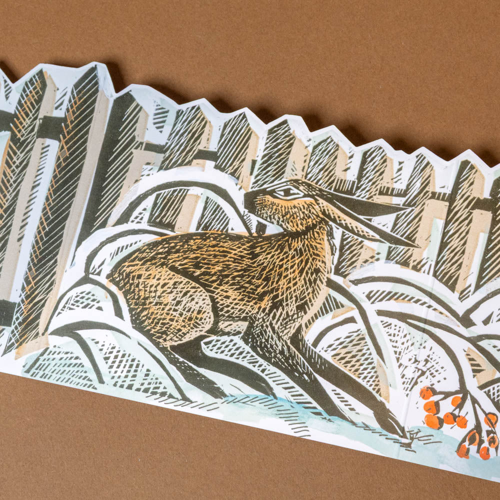 3-d-advent-calendar-christmas-cottage Woodland scene with a deer and trees on a brown background