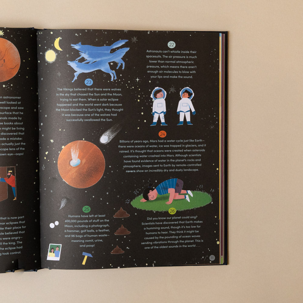 365-amazing-true-things-to-read-in-bed Open book with space-themed illustrations and text on a beige background