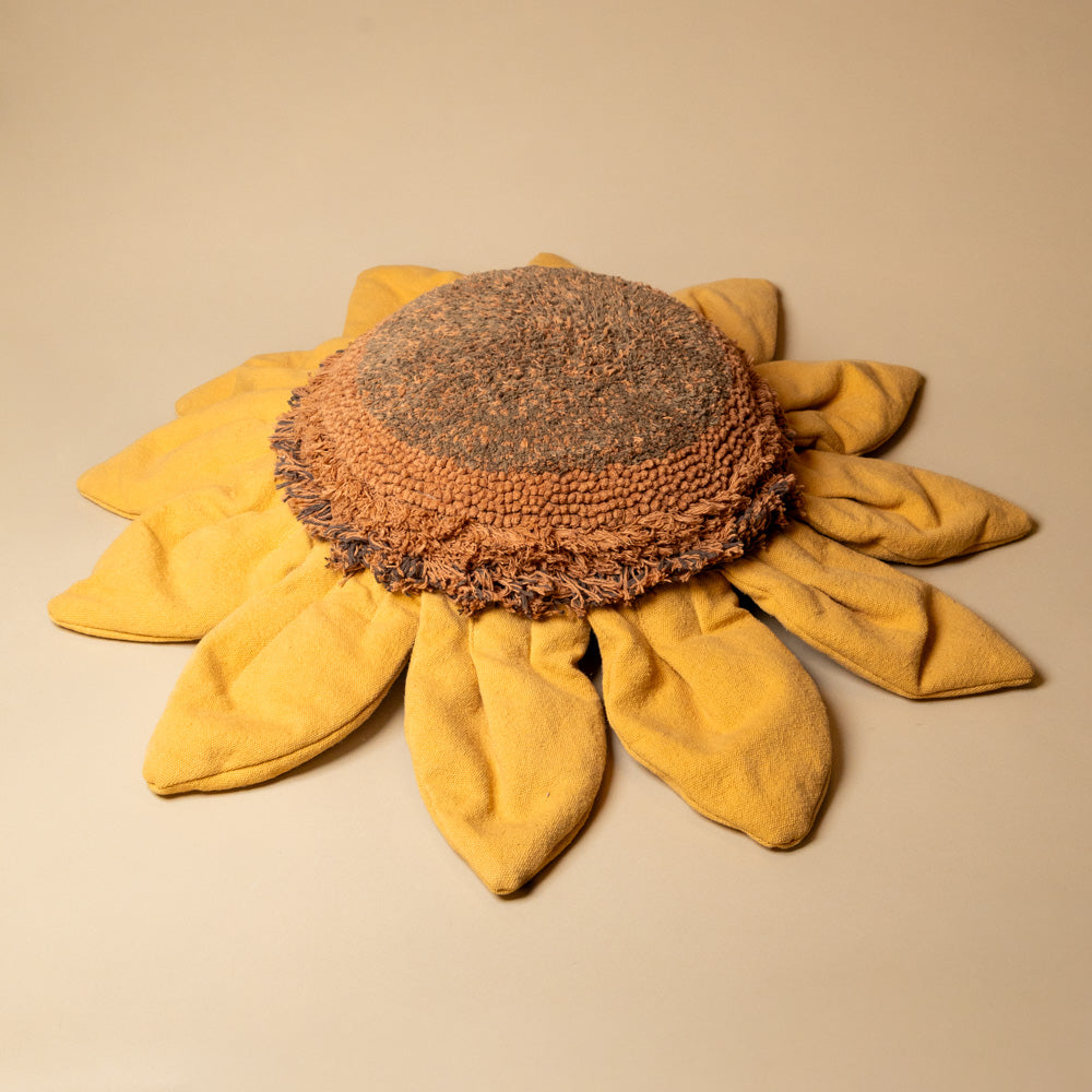 Sunflower-Floor-Cushion Sunflower-shaped pillow with yellow petals and brown center on a beige background