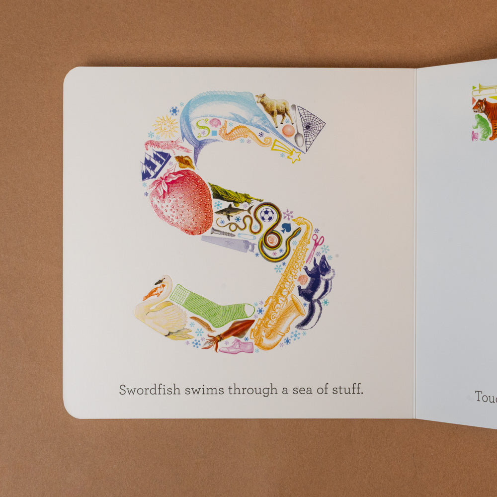 a-b-see Open book with colorful illustration of a swordfish on a brown background