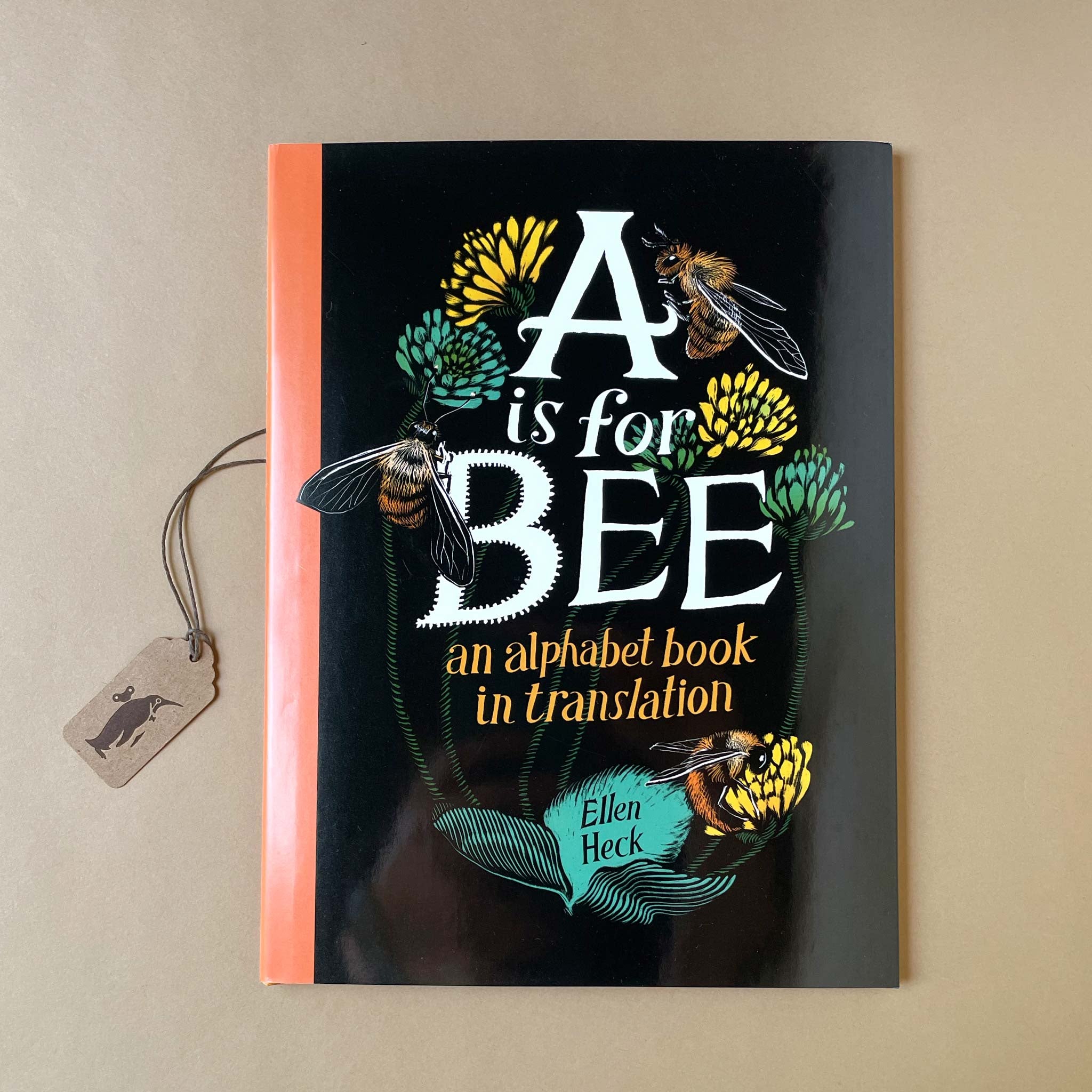 Book titled 'A is for Bee' with bee illustrations on a dark background