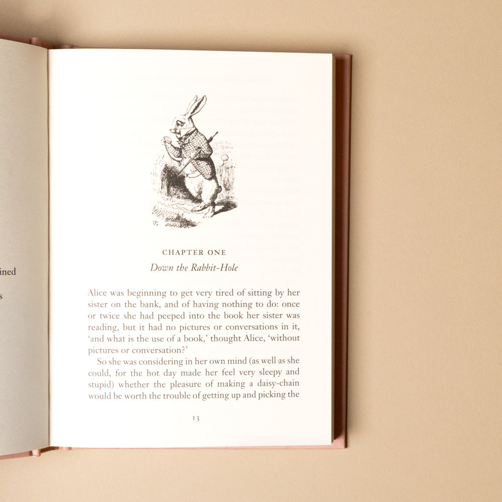 alice-in-wonderland Open book with a rabbit illustration on a beige background
