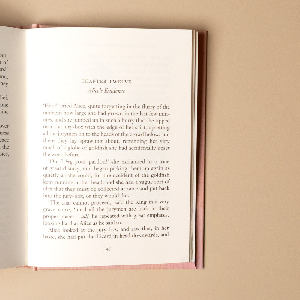 alice-in-wonderland Open book with text on a beige background