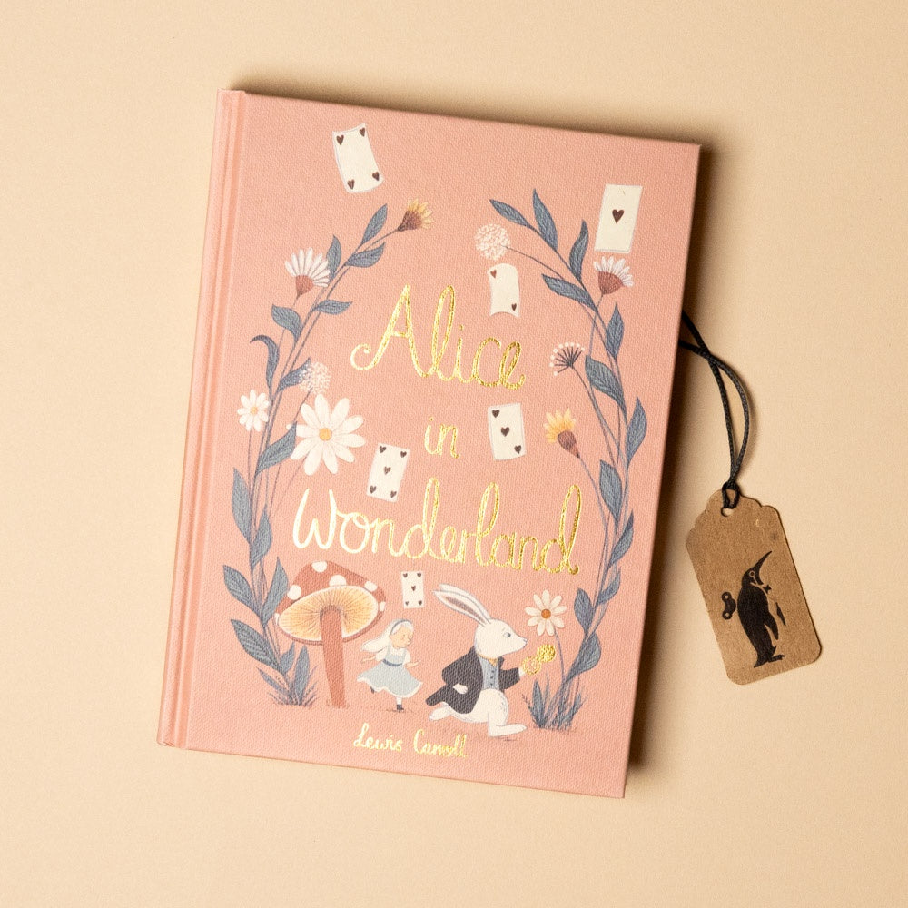 Book titled 'Alice in Wonderland' with illustrations and a tag on a beige background