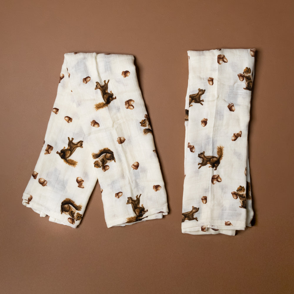 bamboo-burpie-set-chipmunk Two folded white cloths with brown chipmunk pattern on a brown background