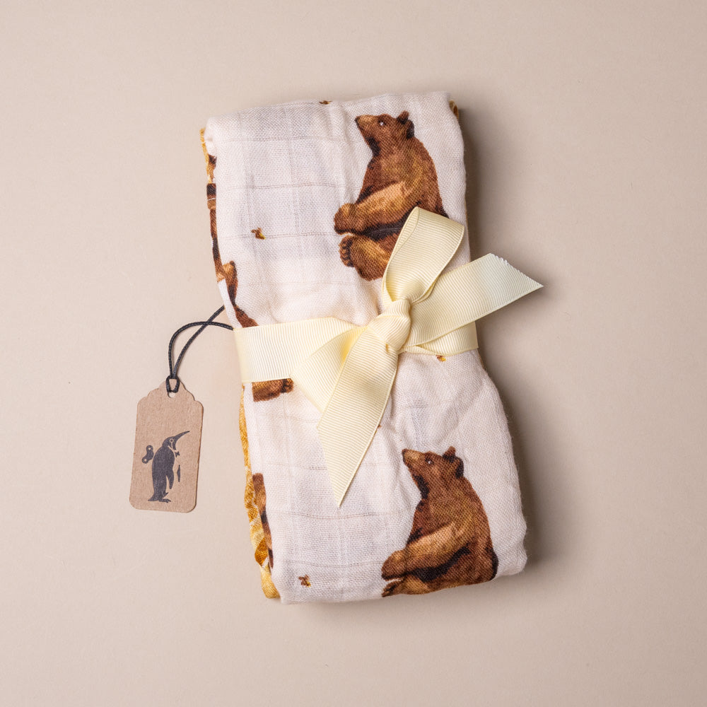 bamboo-burpie-set-honey-bear Folded fabric with bear pattern and ribbon on a beige background