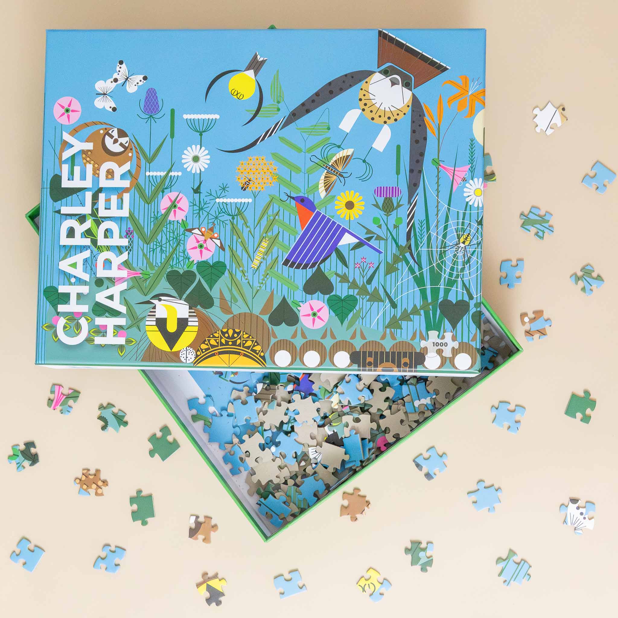 charley-harpers-1000-piece-wild-summer-puzzle-blue-box-wiht-animals-and-flowers-with-example-pieces