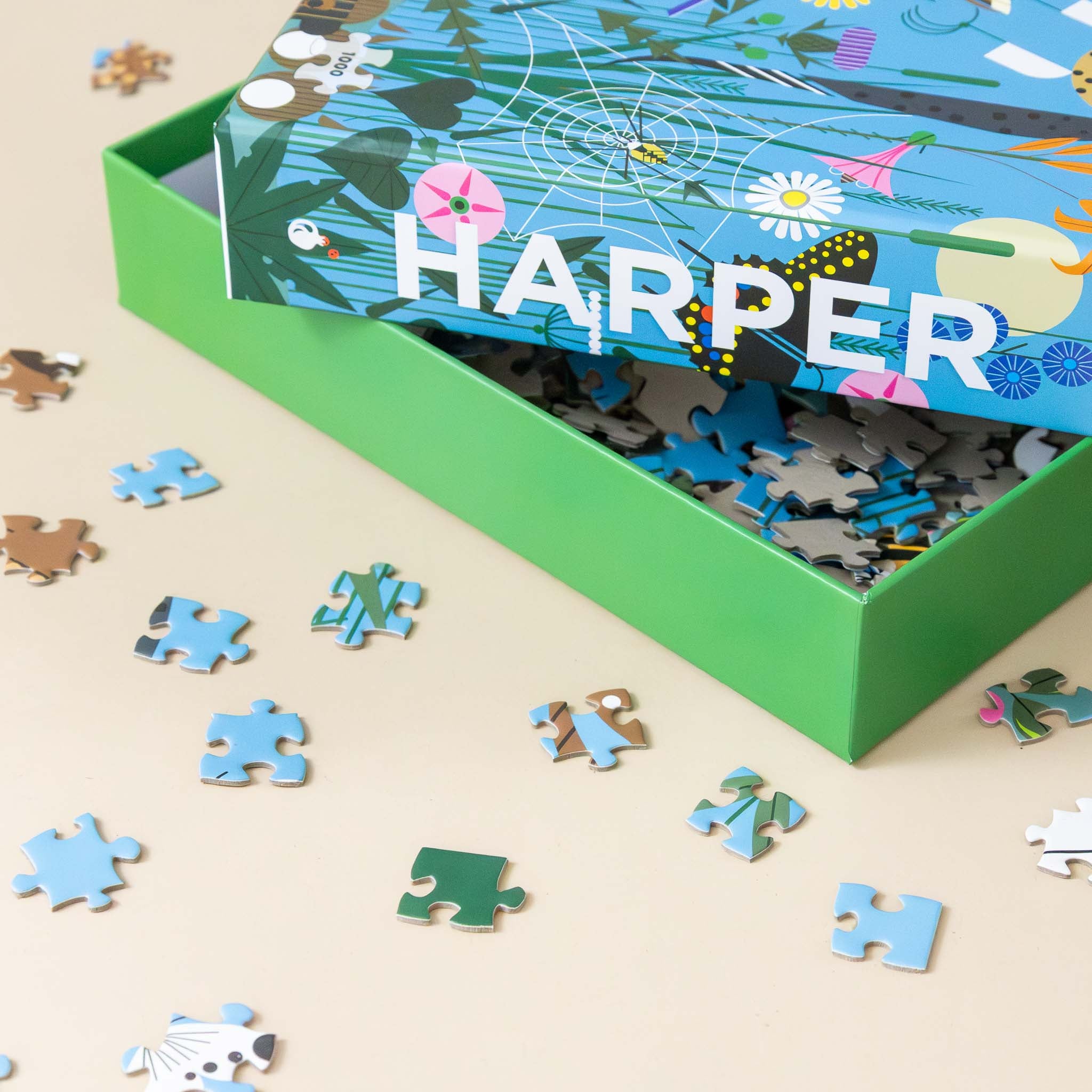 charley-harpers-1000-piece-wild-summer-puzzle-blue-box-wiht-animals-and-flowers-with-example-pieces