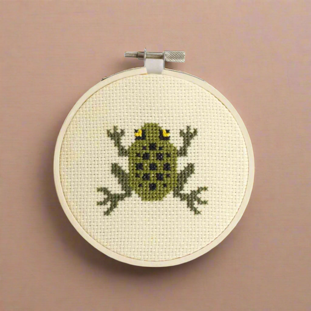 cross-stitch-kit--frog Cross-stitched frog design on a white background