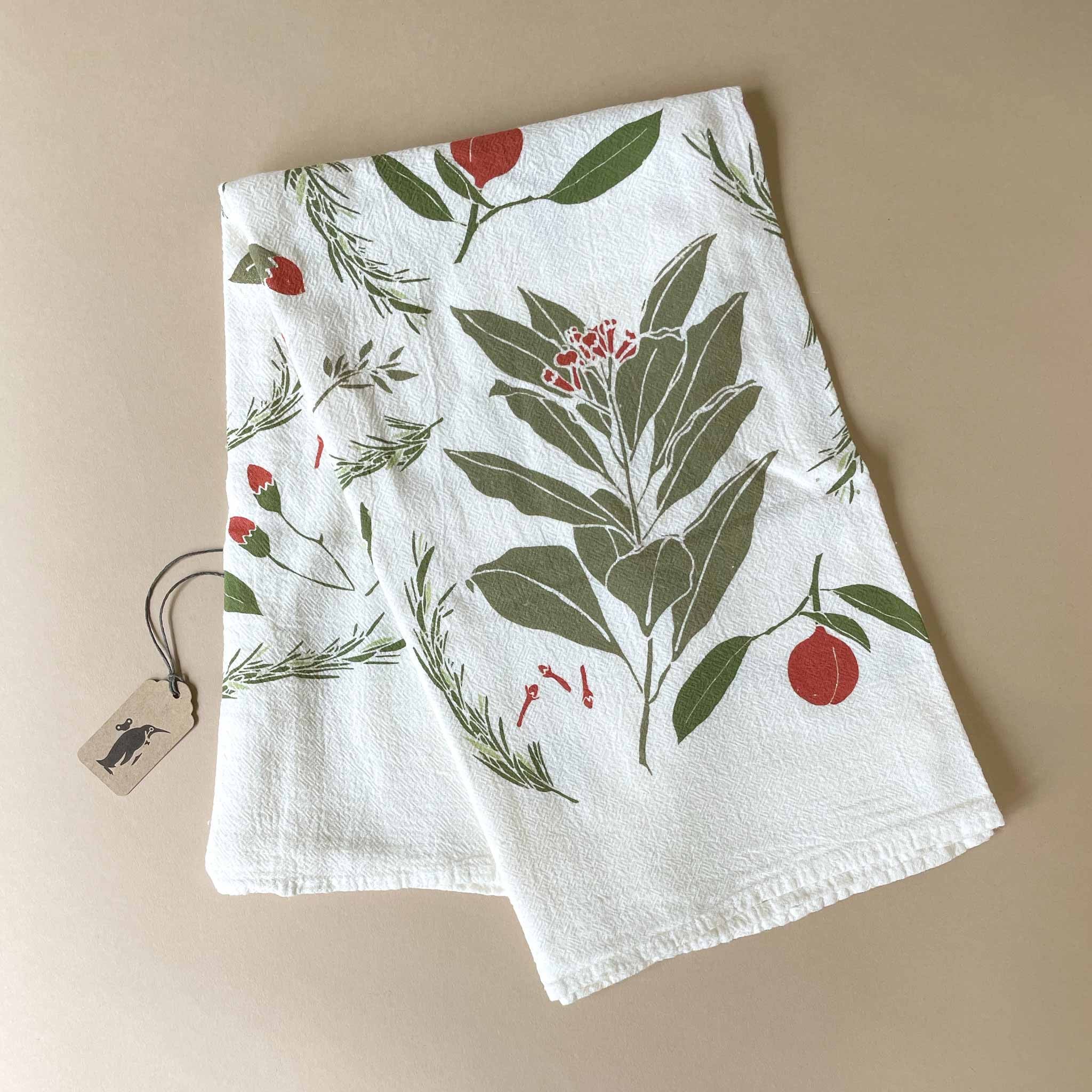 Festive Flavors kitchen towel White towel with green leaf and red berry pattern on a beige background