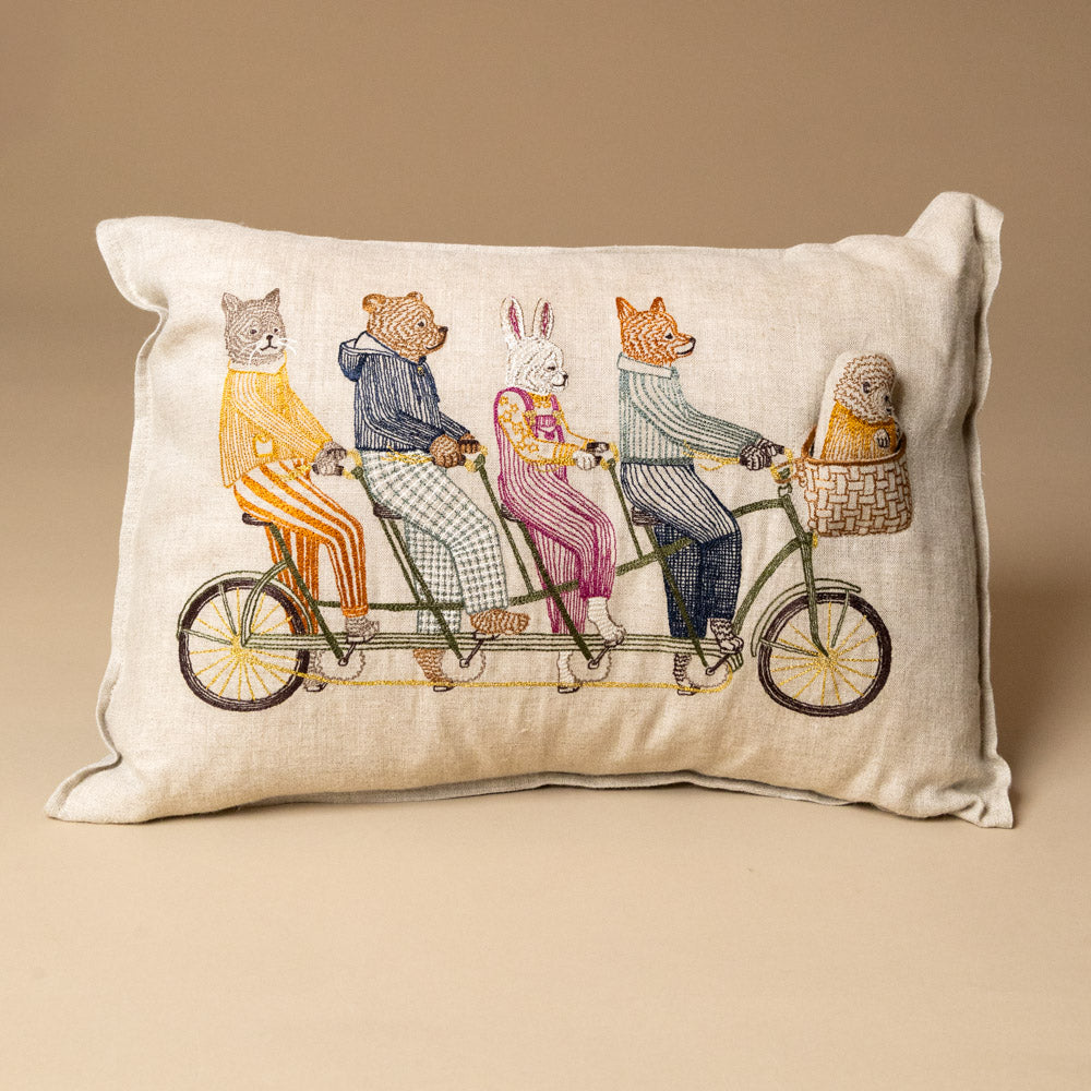embroidered-pocket-pillow-tandem-bike-buddies with animal illustration of people on a tandem bicycle.
