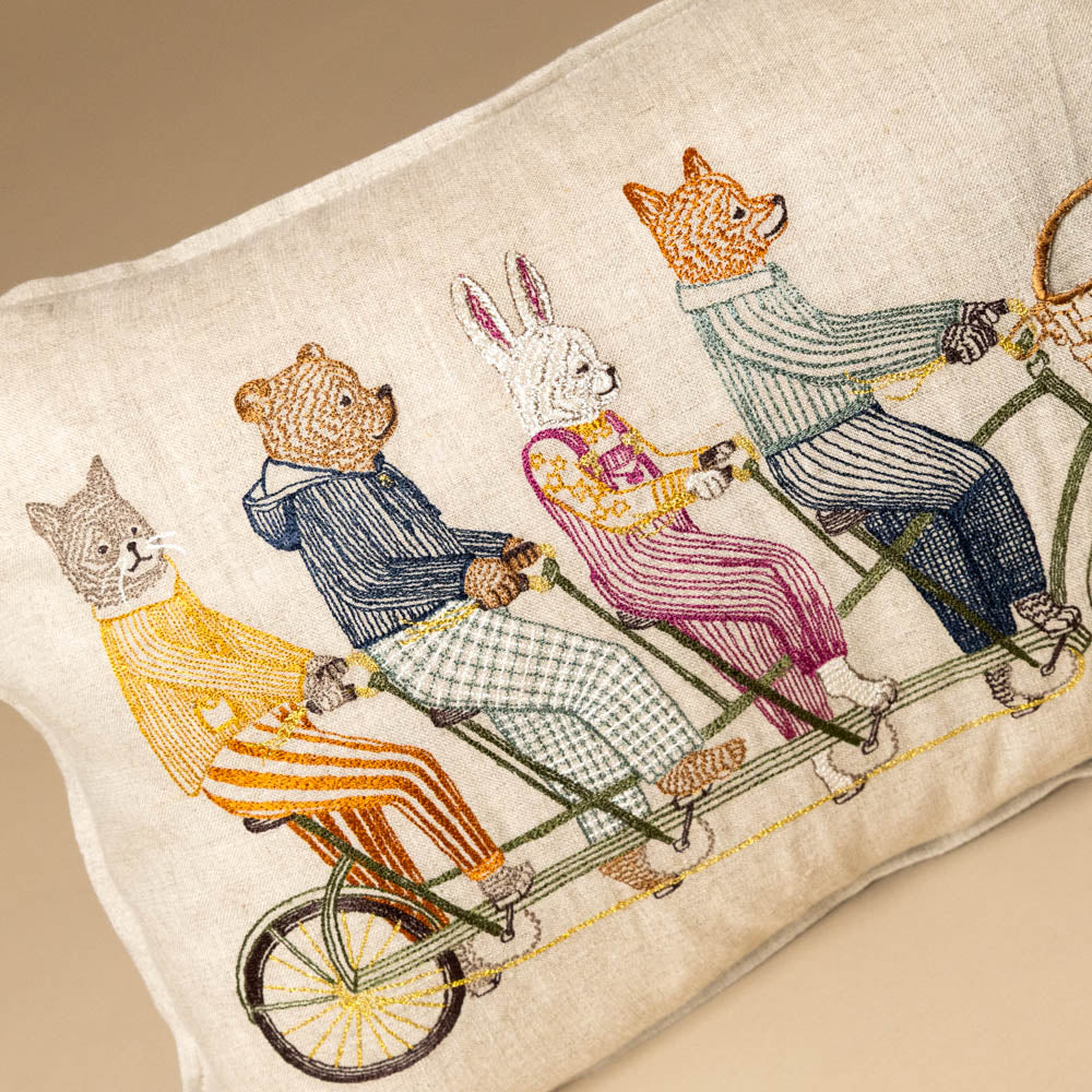 embroidered-pocket-pillow-tandem-bike-buddies of animals on a bicycle on a pillow