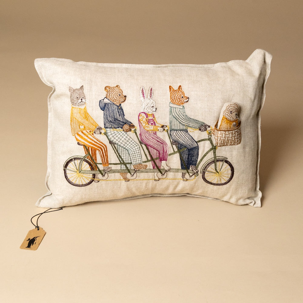 embroidered-pocket-pillow-tandem-bike-buddies of animals on a bicycle on a beige background