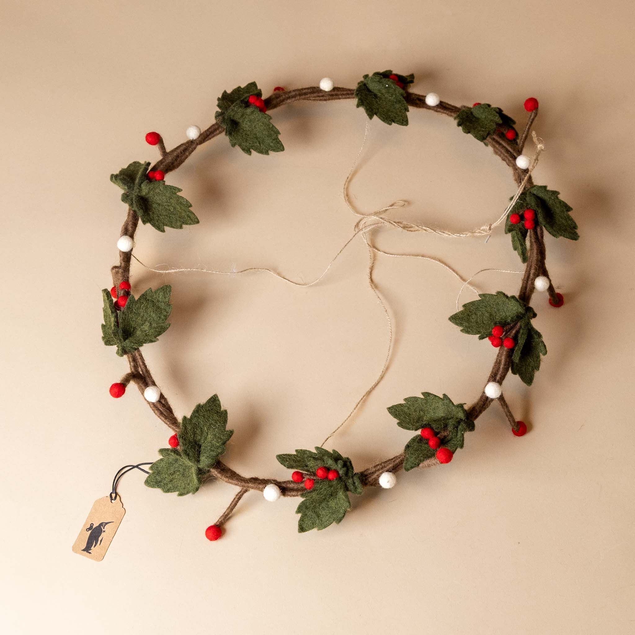 felt-holly-wreath-hanging-red-white-berries