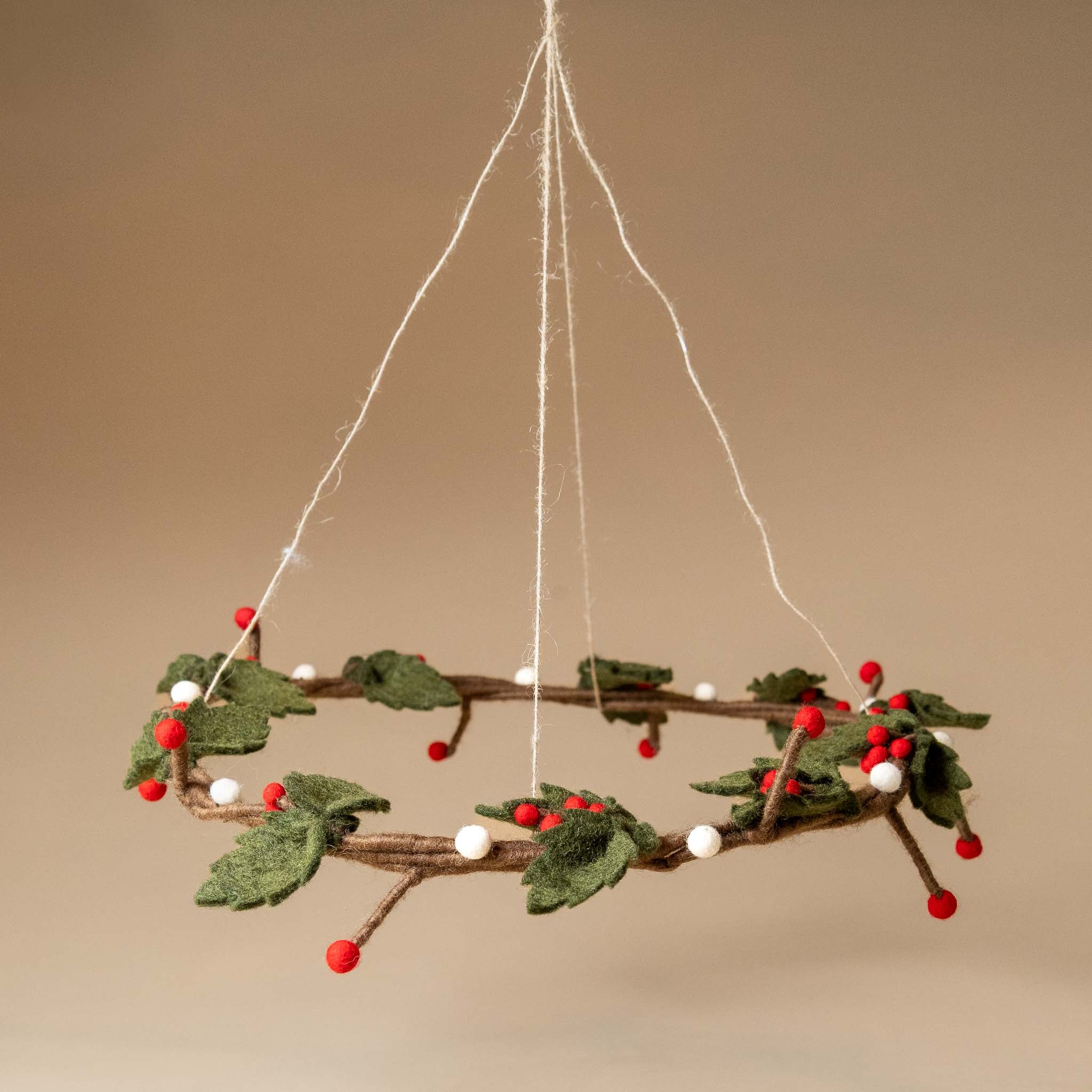 felt-holly-wreath-hanging-red-white-berries