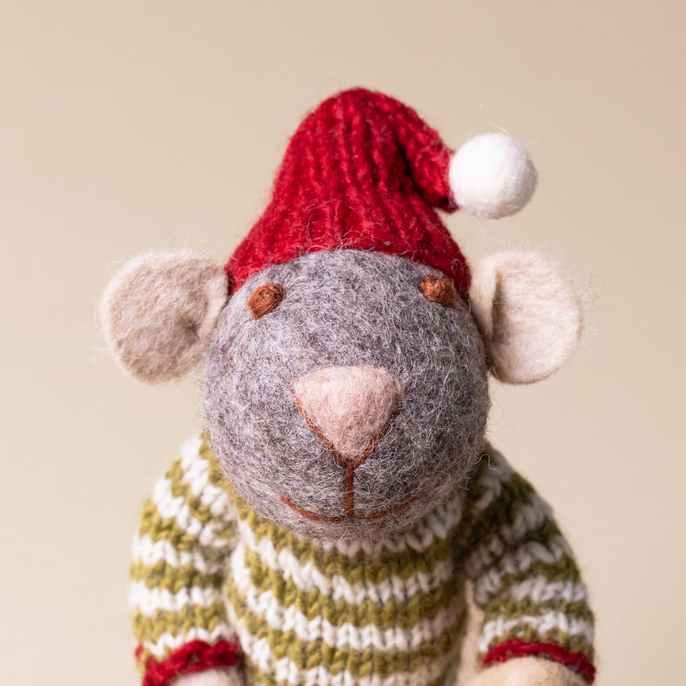 felted-grey-mouse-green-striped-sweater-with-mushroom-bucket Knitted mouse toy wearing a red hat and striped sweater on a beige background