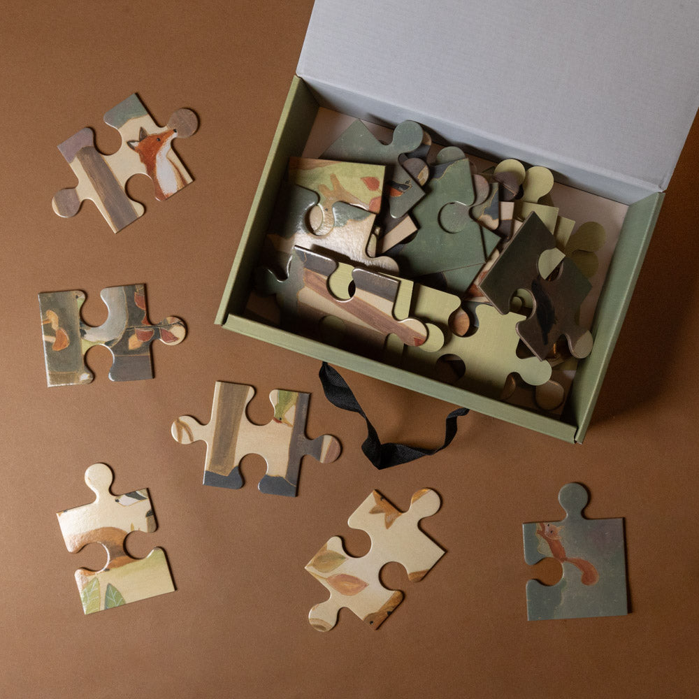 forest-36-piece-puzzlewith animal illustrations on a brown surface