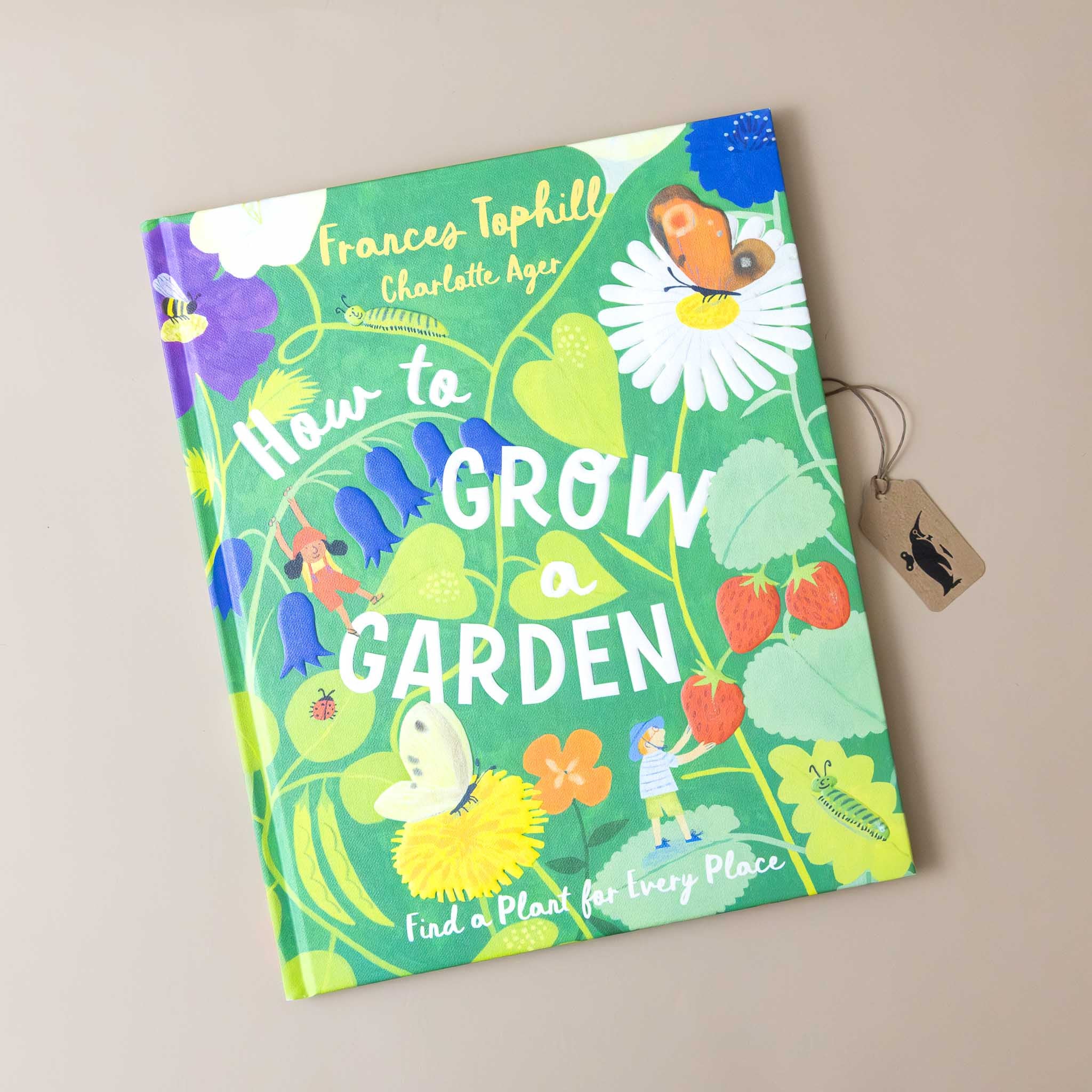 how-to-grow-a-garden-book-cover-with-green-garden-illustration-of-miniature-person-picking-strawberries-amongst-flowers-and-butterflies-and-bugs