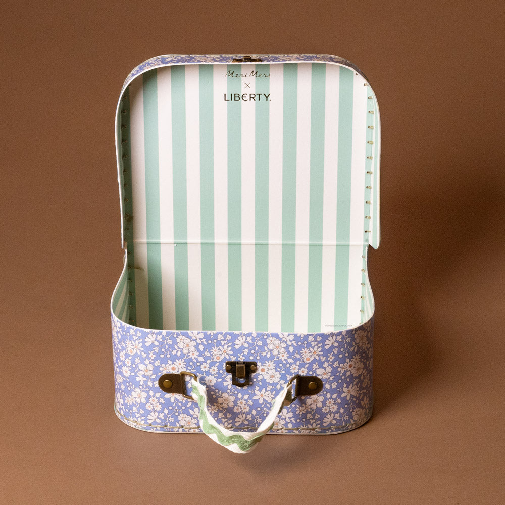 liberty-suitcase-small-inside-Striped fabric in a floral-patterned suitcase on a brown background