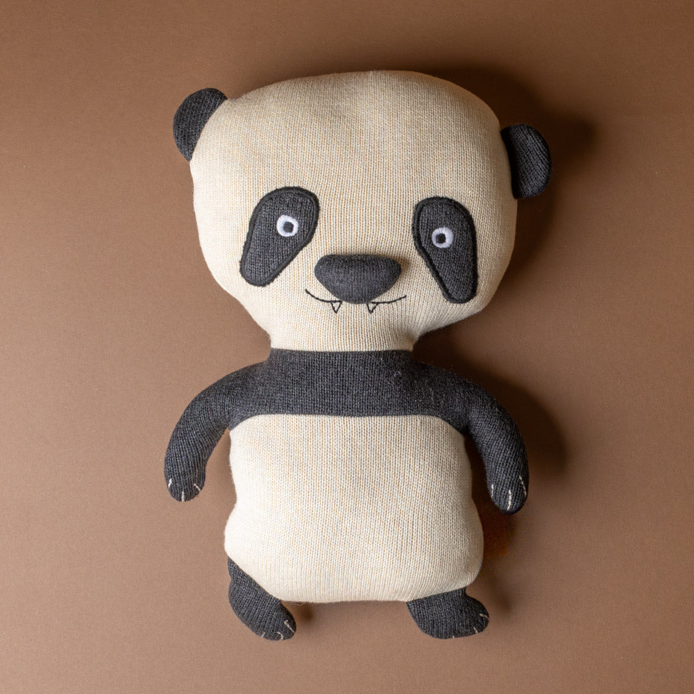 ling-ling-panda-bear Stuffed panda toy on a brown background