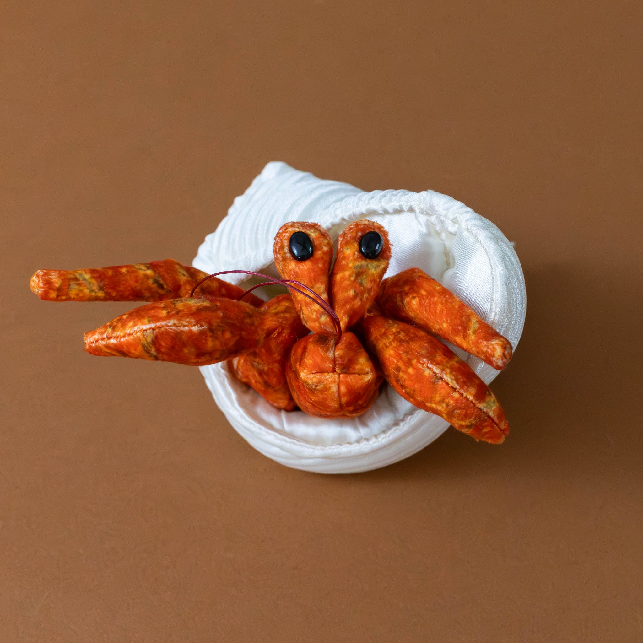 little-orange-hermit-crab-finger-puppet-with-white-corded-shell