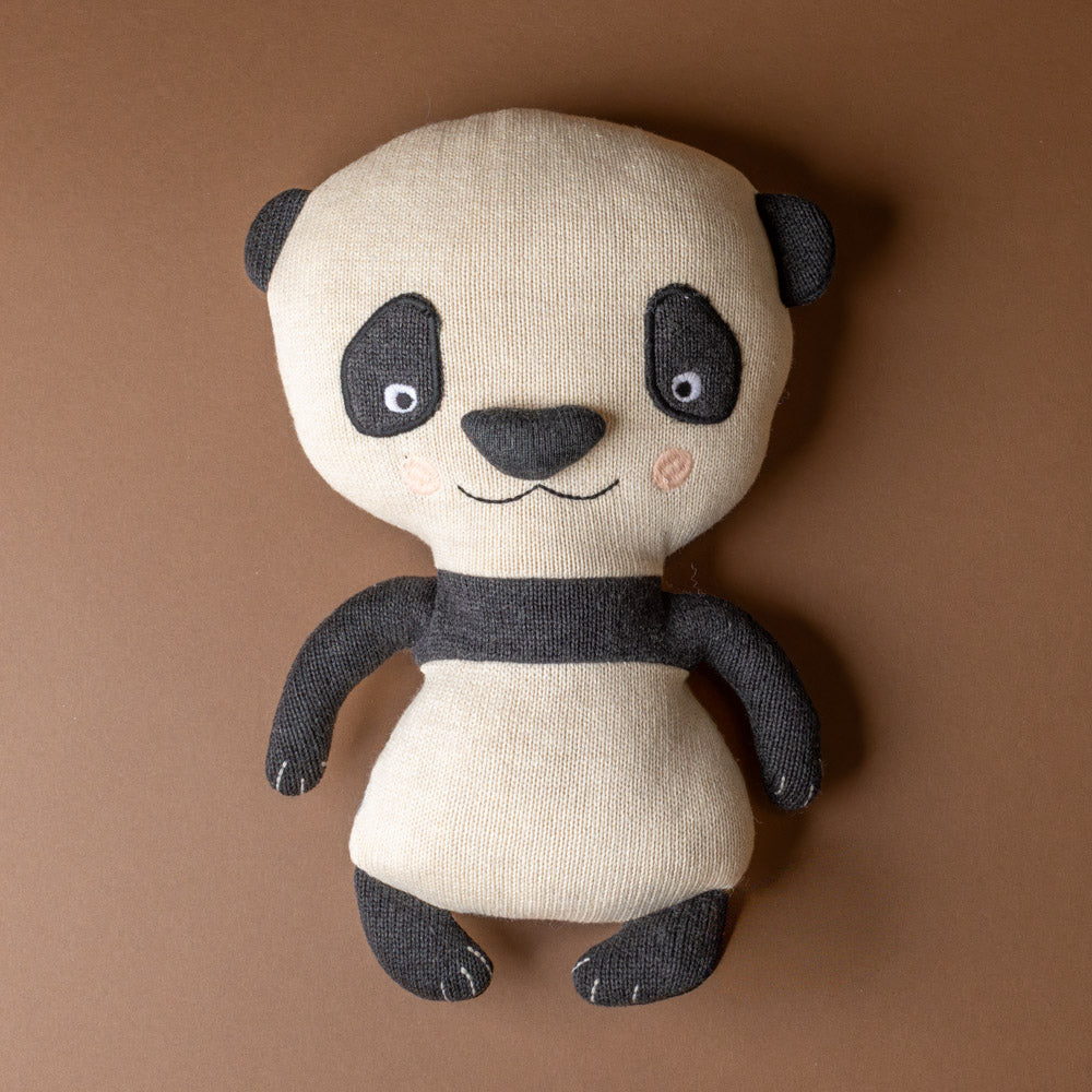 lun-lun-panda-bear Stuffed panda toy on a brown background