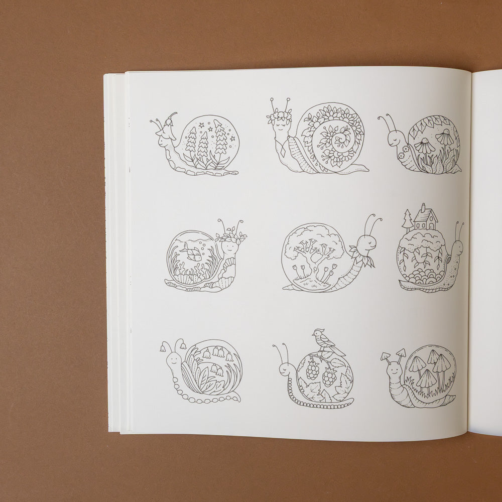 magical-worlds-coloring-book Open book with line drawings of snails on a brown background