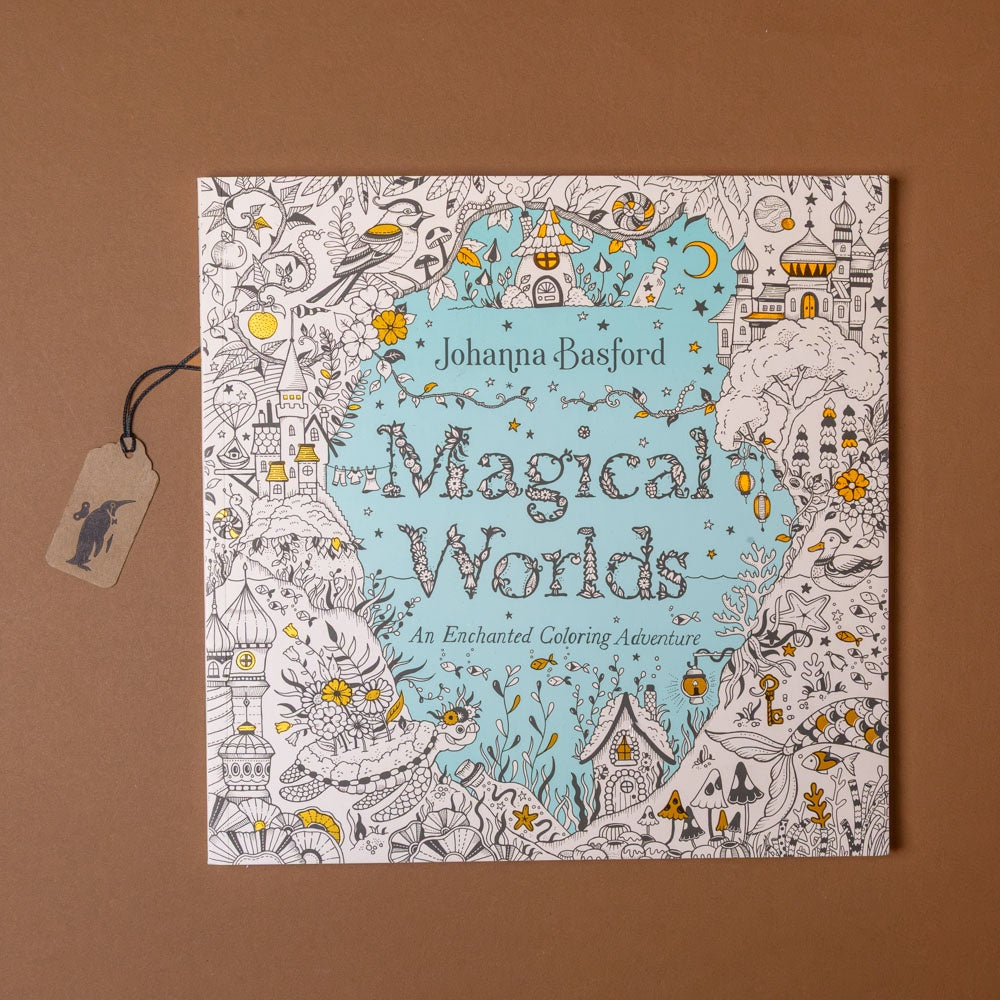 Coloring book titled 'Magical Worlds' by Johanna Basford on a brown background