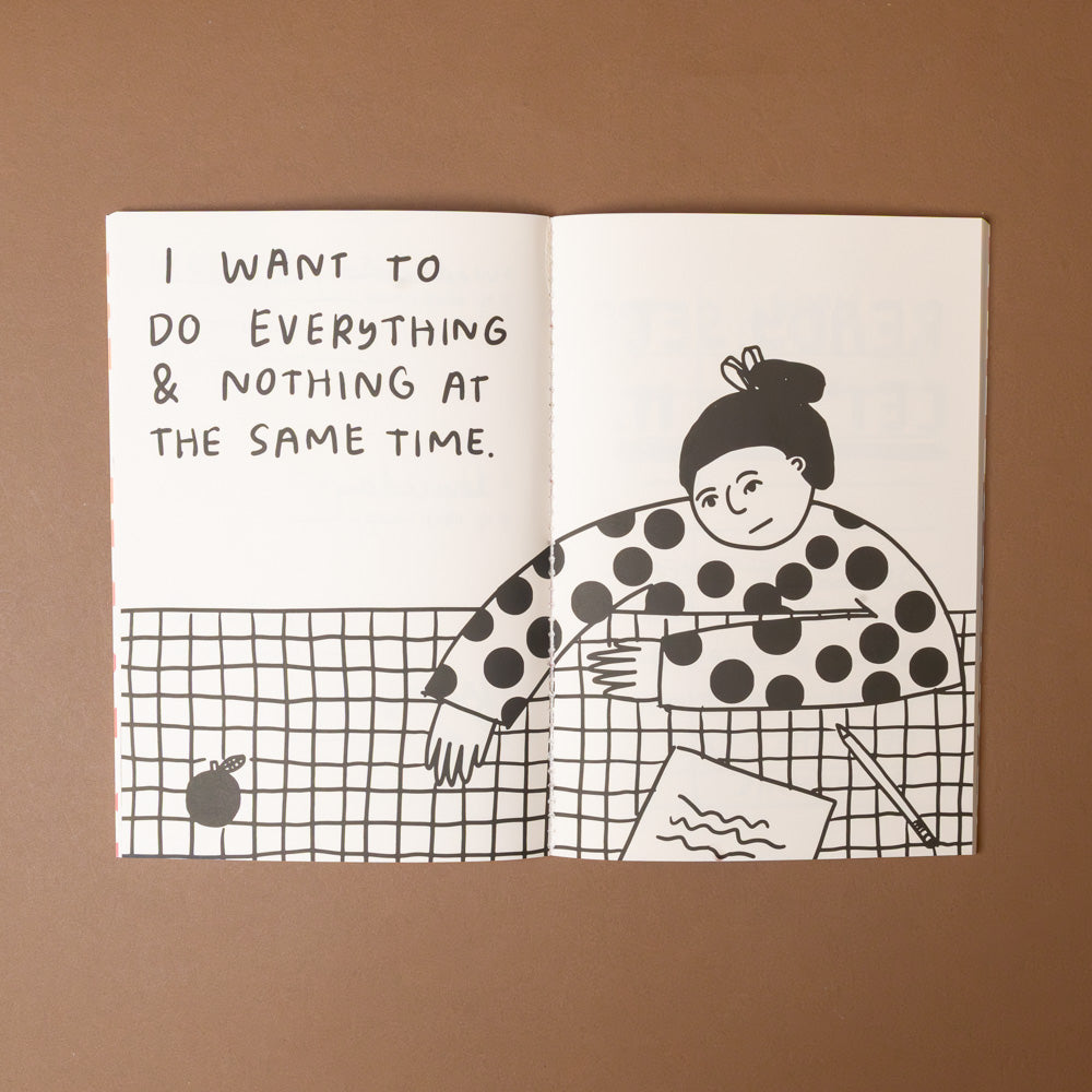 make-it-happen-journal-despite-being-really-scared Open book with black and white illustration of a person multitasking and text 'I want to do everything & nothing at the same time.' on a brown background.