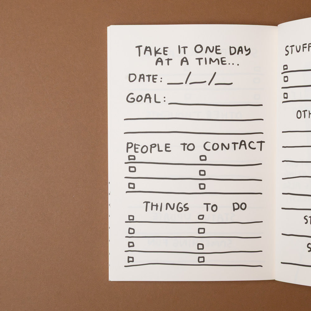 make-it-happen-journal-despite-being-really-scared Handwritten checklist in a notebook on a brown background