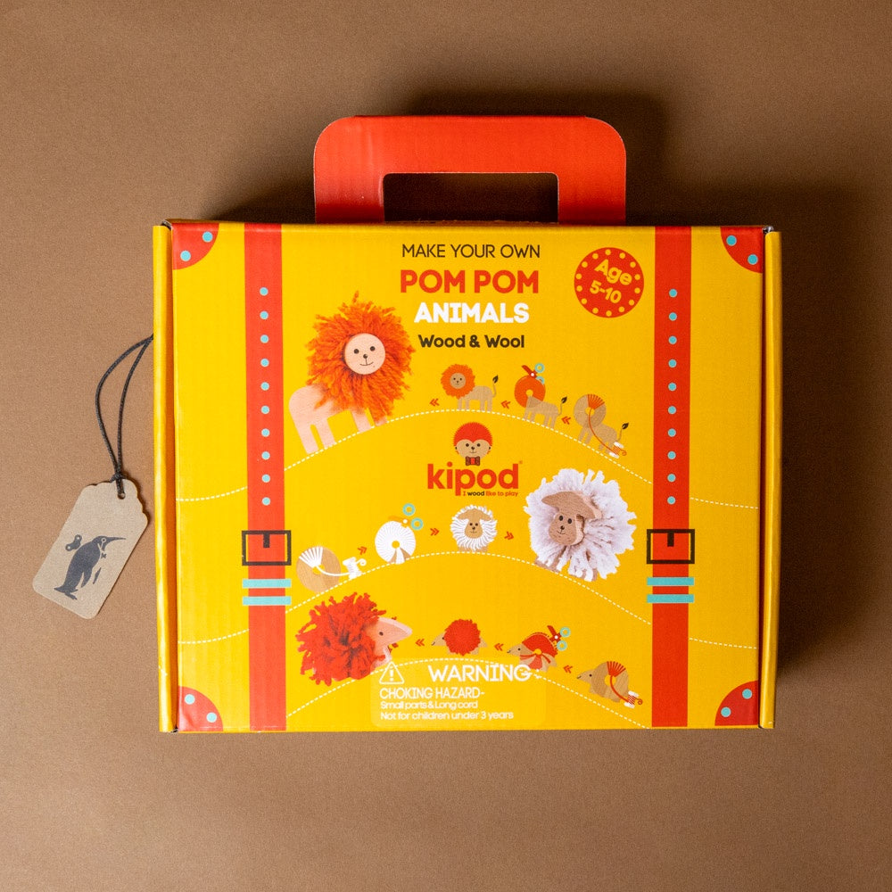 Yellow and red box with pom pom animals branding on a brown background