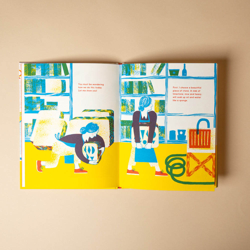 meet-the-lithographer Open book with colorful illustrations of two characters in a room.