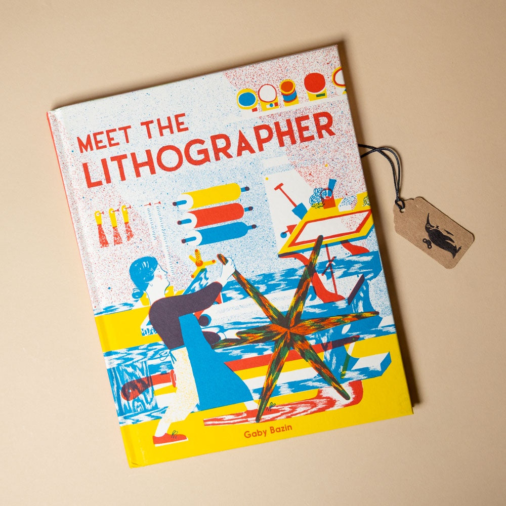 Book titled 'Meet the Lithographer' with colorful design on a beige background