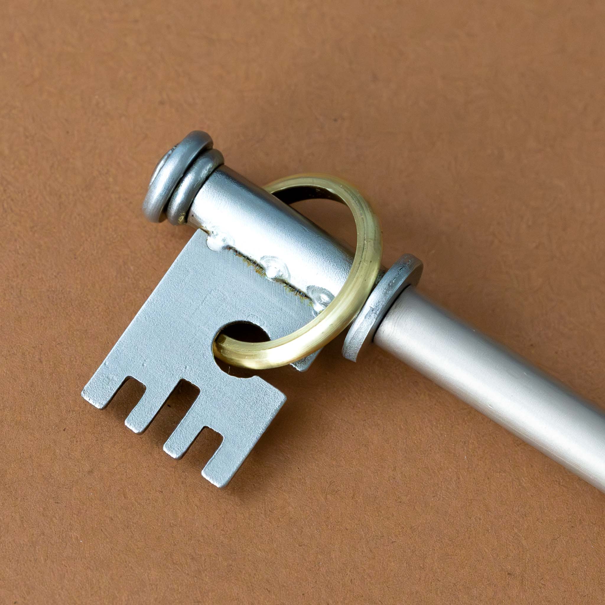 metal-key-to-the-answers-puzzle-with-gold-ring-skeleton-key