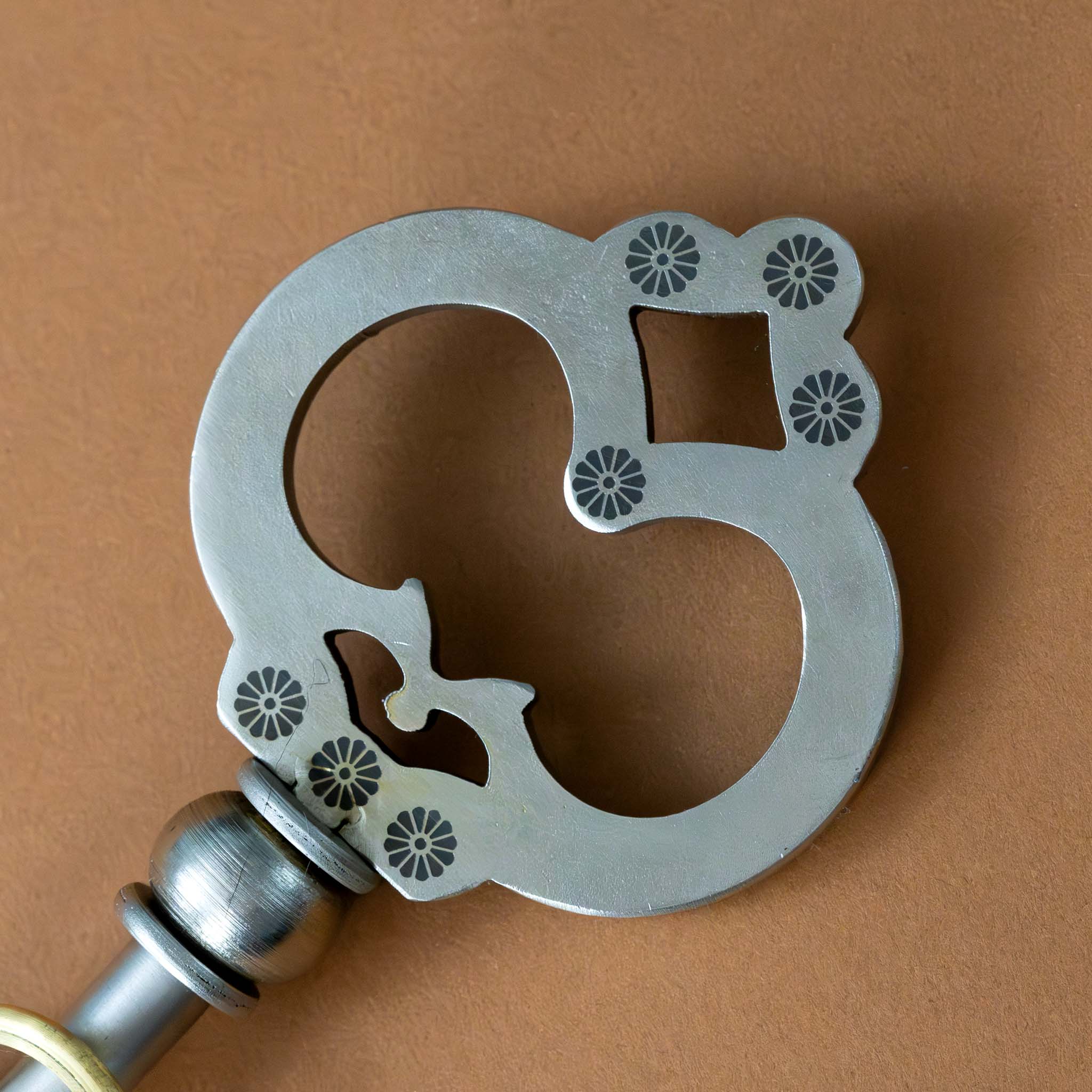 metal-key-to-the-answers-puzzle-with-gold-ring-top-with-detail