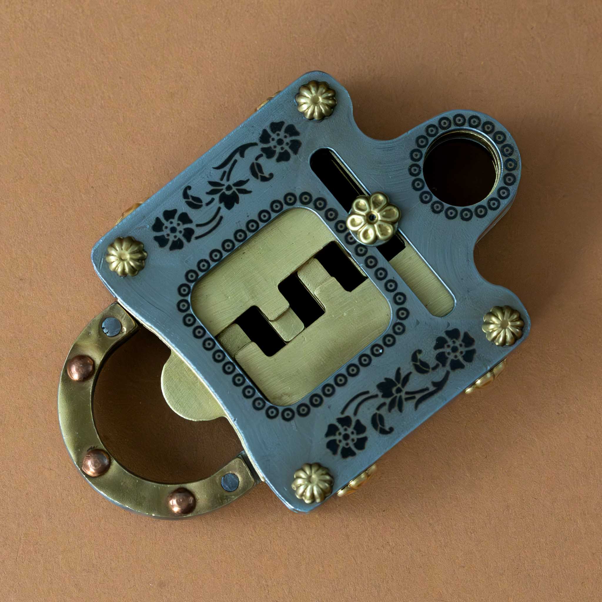 metal-un-locking-puzzle-brass-and-silver-colored-with-floral-detail-back-of-puzzle