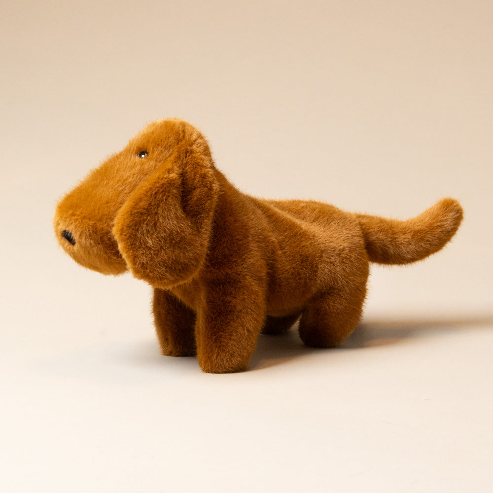 muzzle-dale-dachshund-pup-large Brown plush dog toy on a beige background