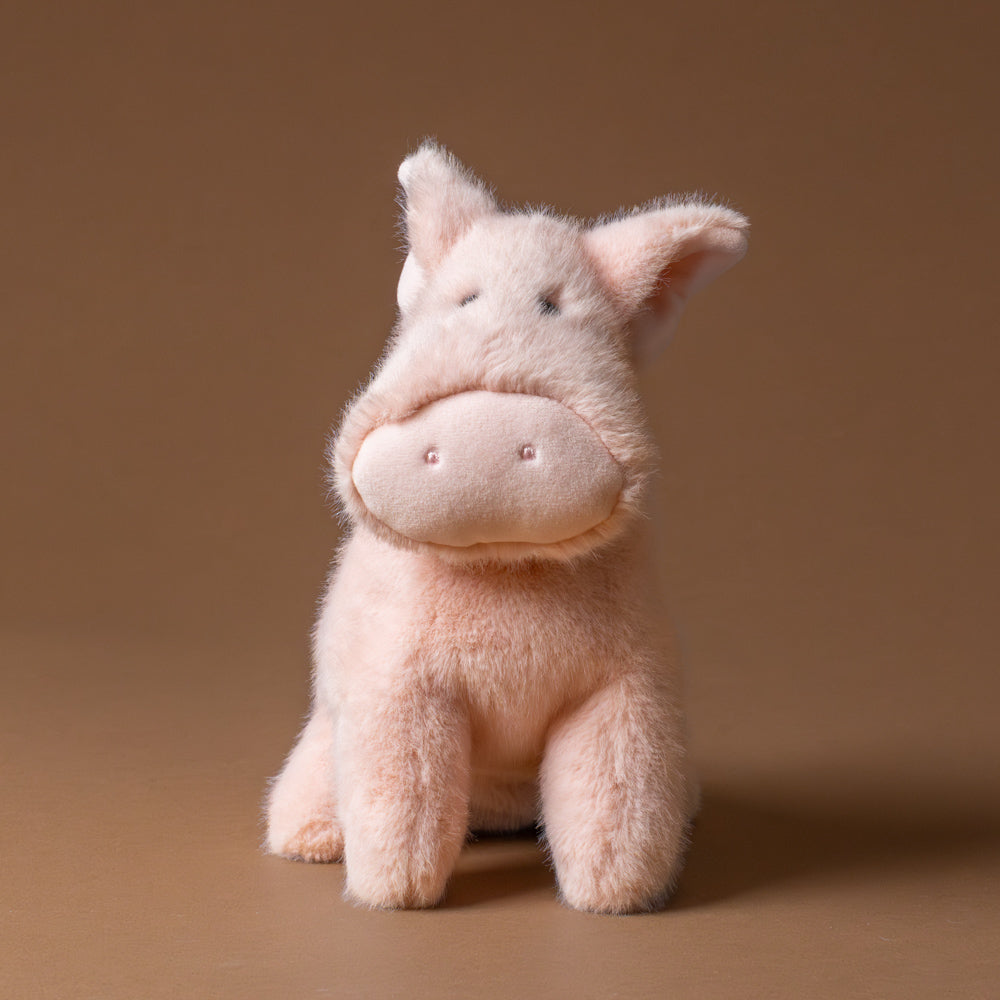 muzzle-peter-pig-large Plush pig toy on a brown background