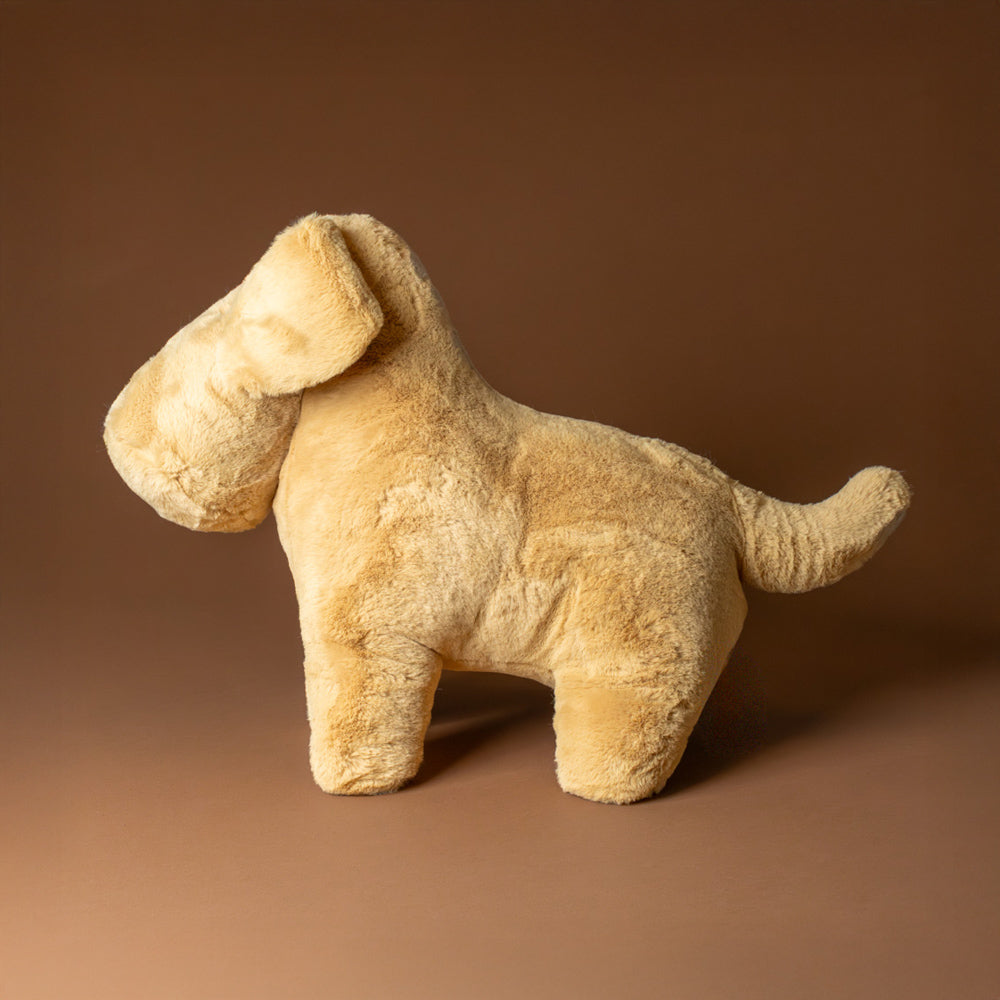 muzzle-tim-tan-pup-jumbo stuffed dog toy on a brown background