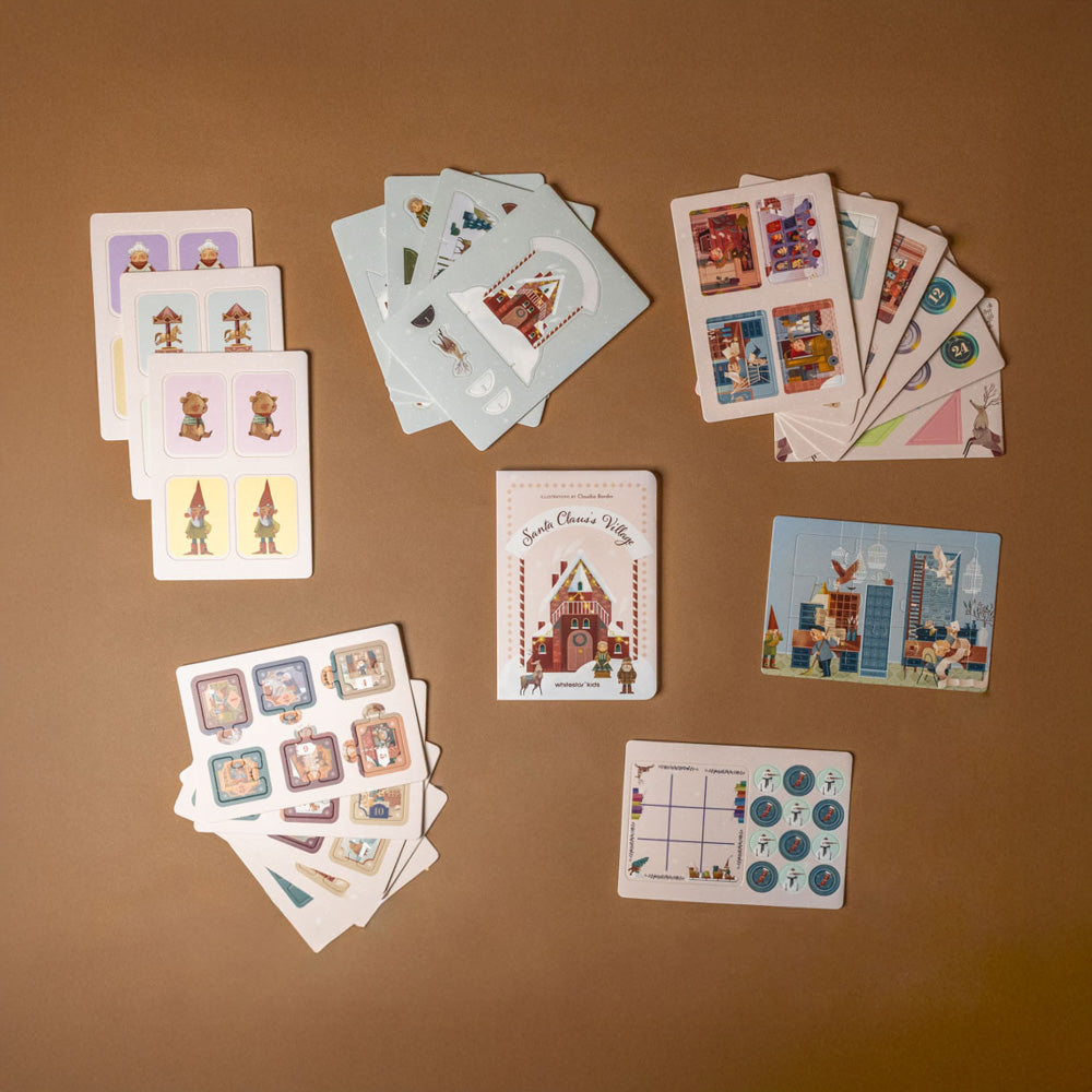 my-little-interactive-box-of-christmas-games Collection of illustrated cards on a brown surface