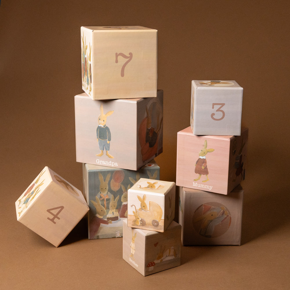 nesting-blocks-rabbit-family Stack of decorative blocks with numbers and animal illustrations on a brown background