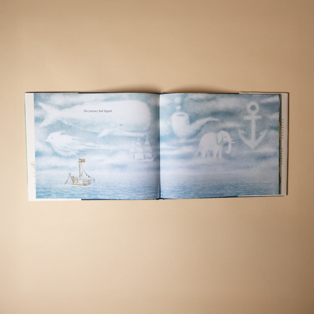 ocean-meets-sky Open book with illustrations of a boat, anchor, and elephant on a beige background