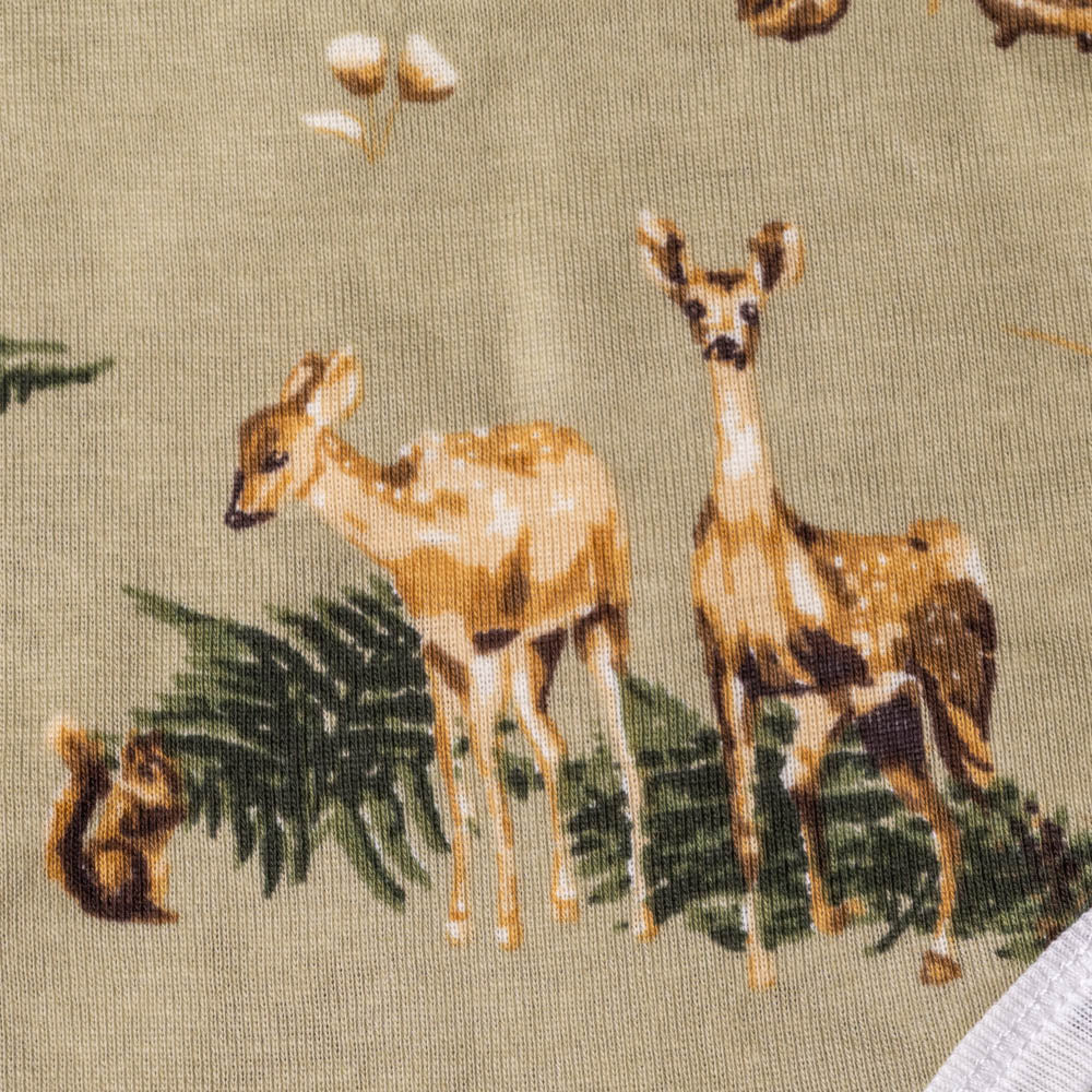 organic-cotton-long-sleeve-onesie-forest-party Fabric with deer and squirrel pattern on a green background