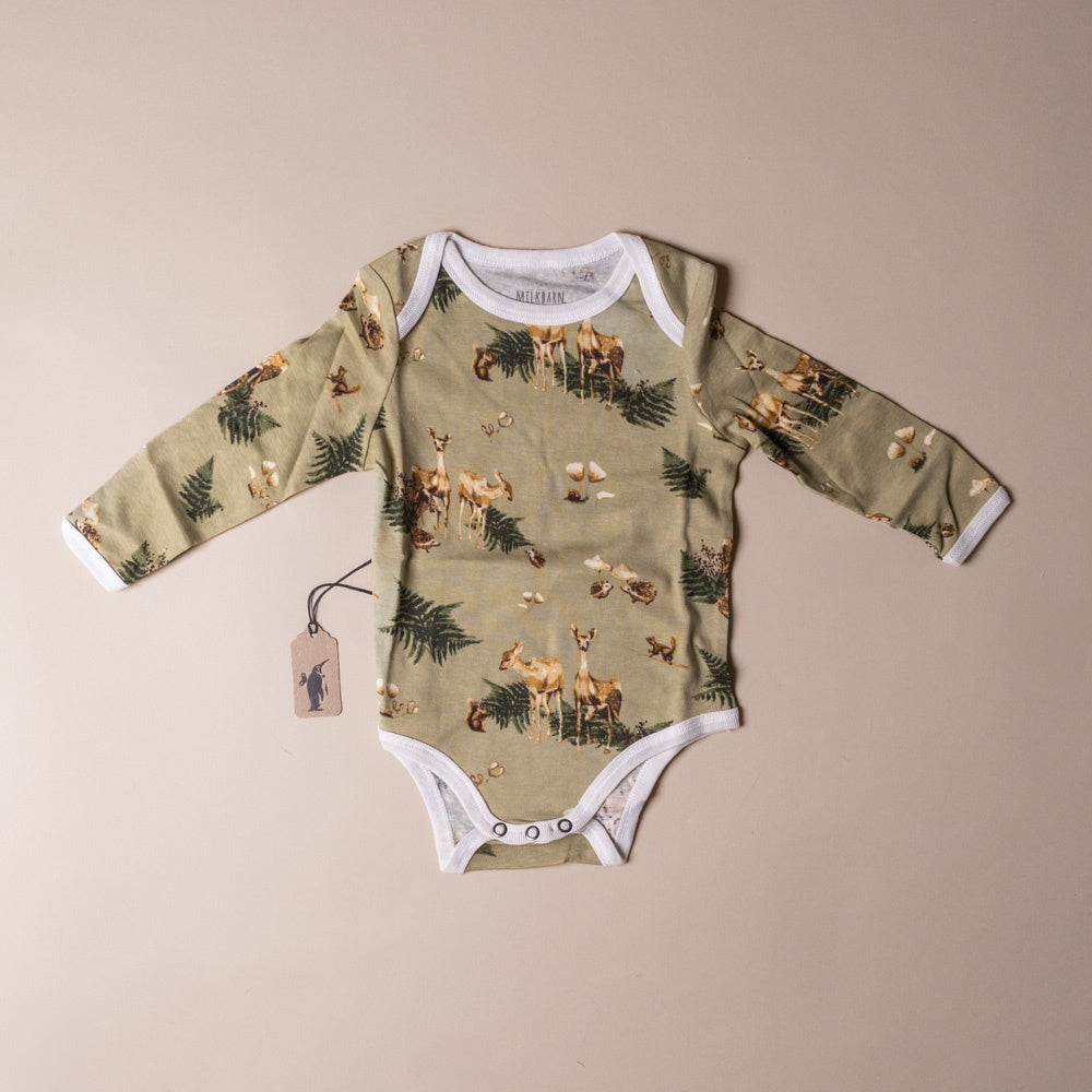 Baby organic-cotton-long-sleeve-onesie-forest-party with nature-themed print on a beige background