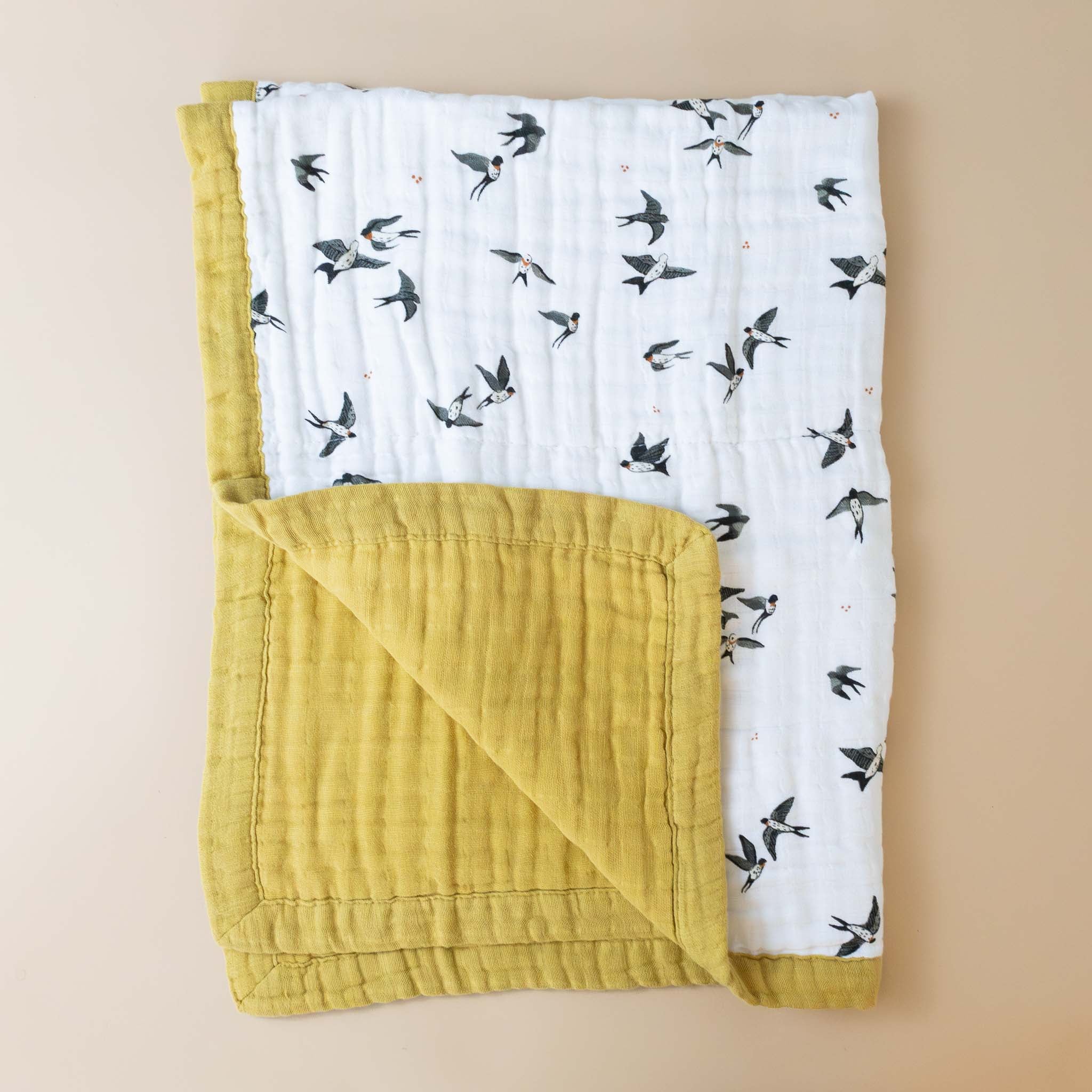 organic-cotton-muslin-blanket-swallows-ocher-trim