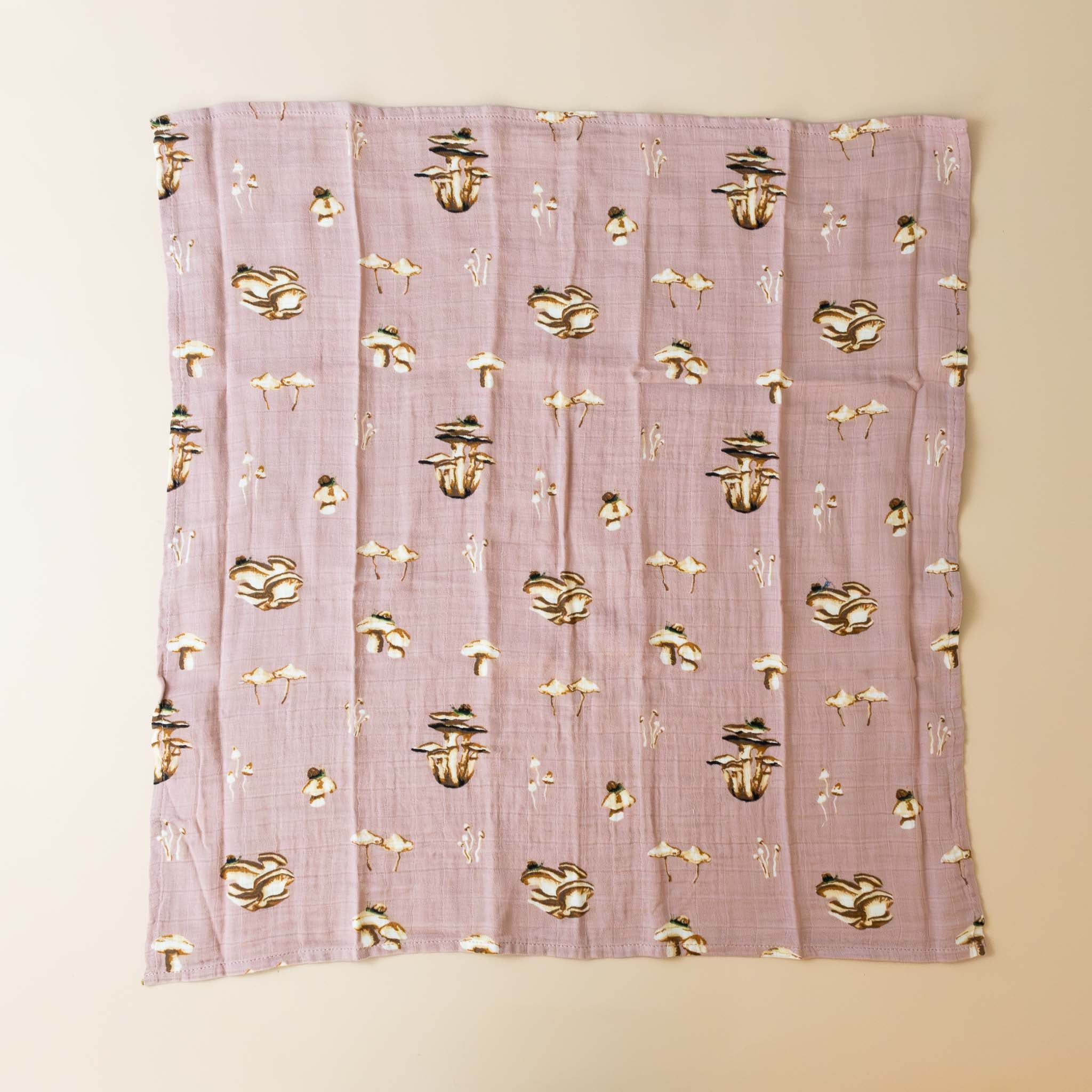 organic-cotton-swaddle-mushrooms-pink-background-with-mushrooms