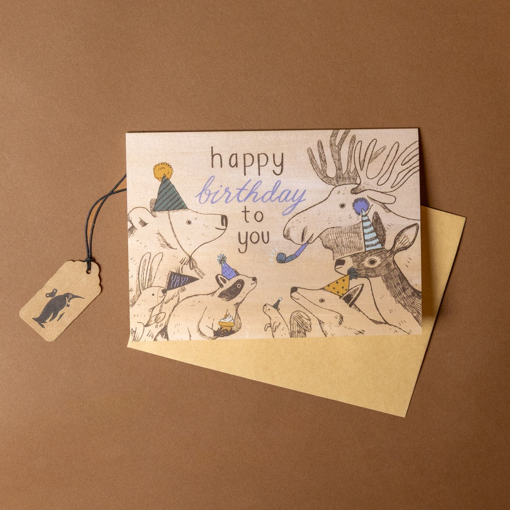 party-in-the-woods-birthday-greeting-card- with animal illustrations and 'happy birthday to you' text on a brown background