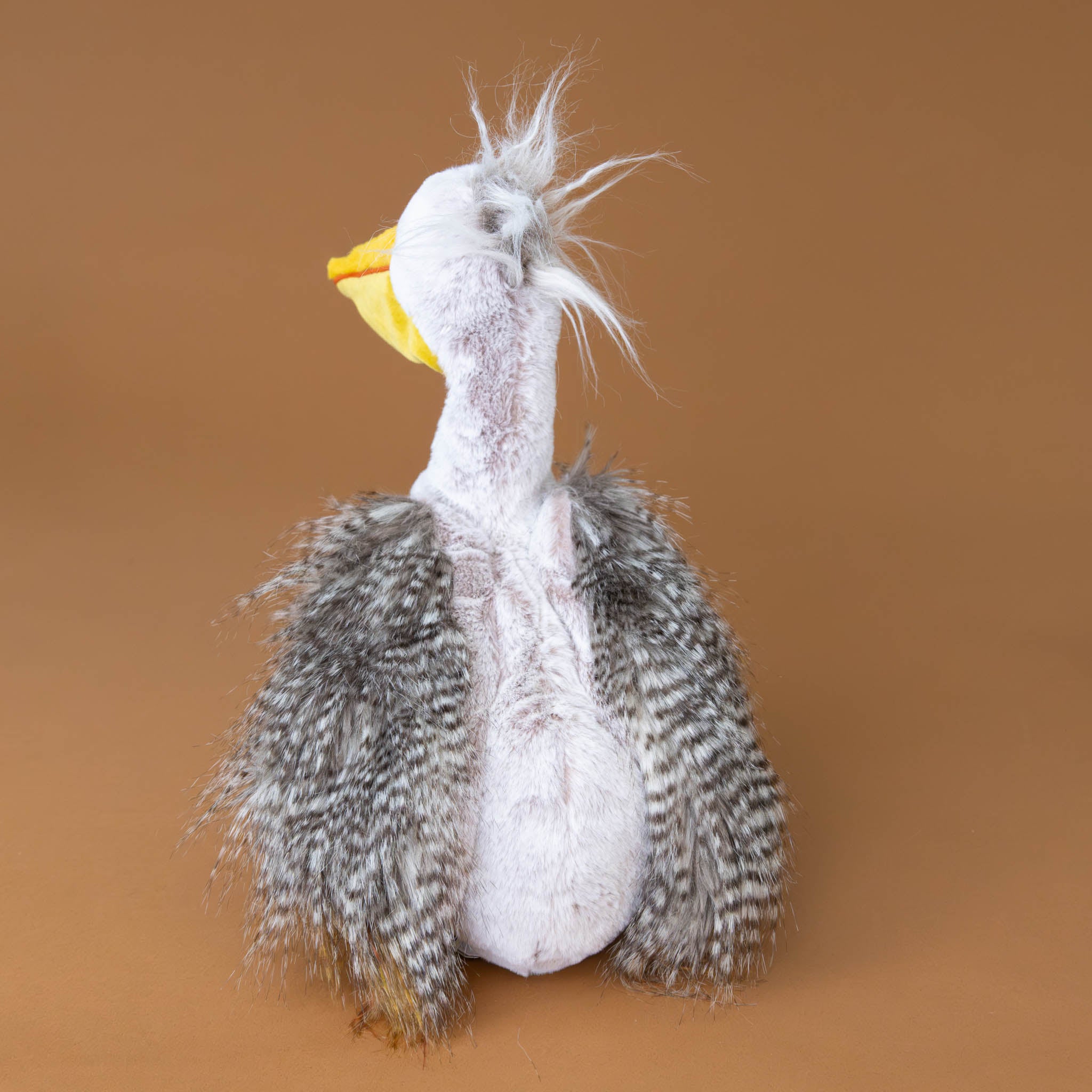 peculiar-pelican-stuffed-animal-with-soft-grey-feathery-fur-and-yellow-beak-and-feet-back